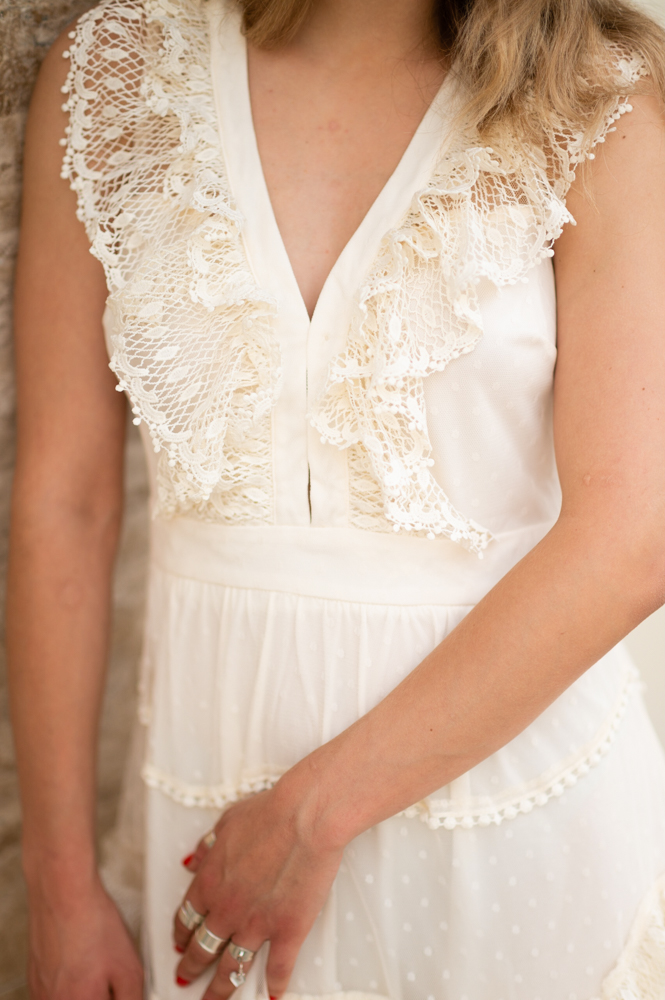 Βlonde woman wears romantic dress with embroidery in beige