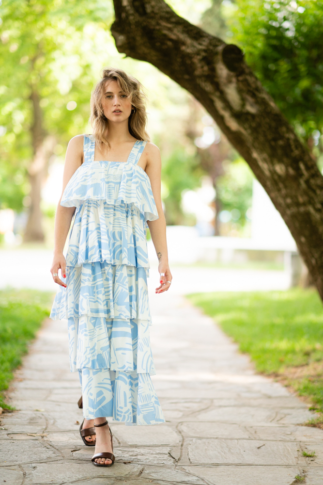Blonde girl wearing maxi printed dress in light blue