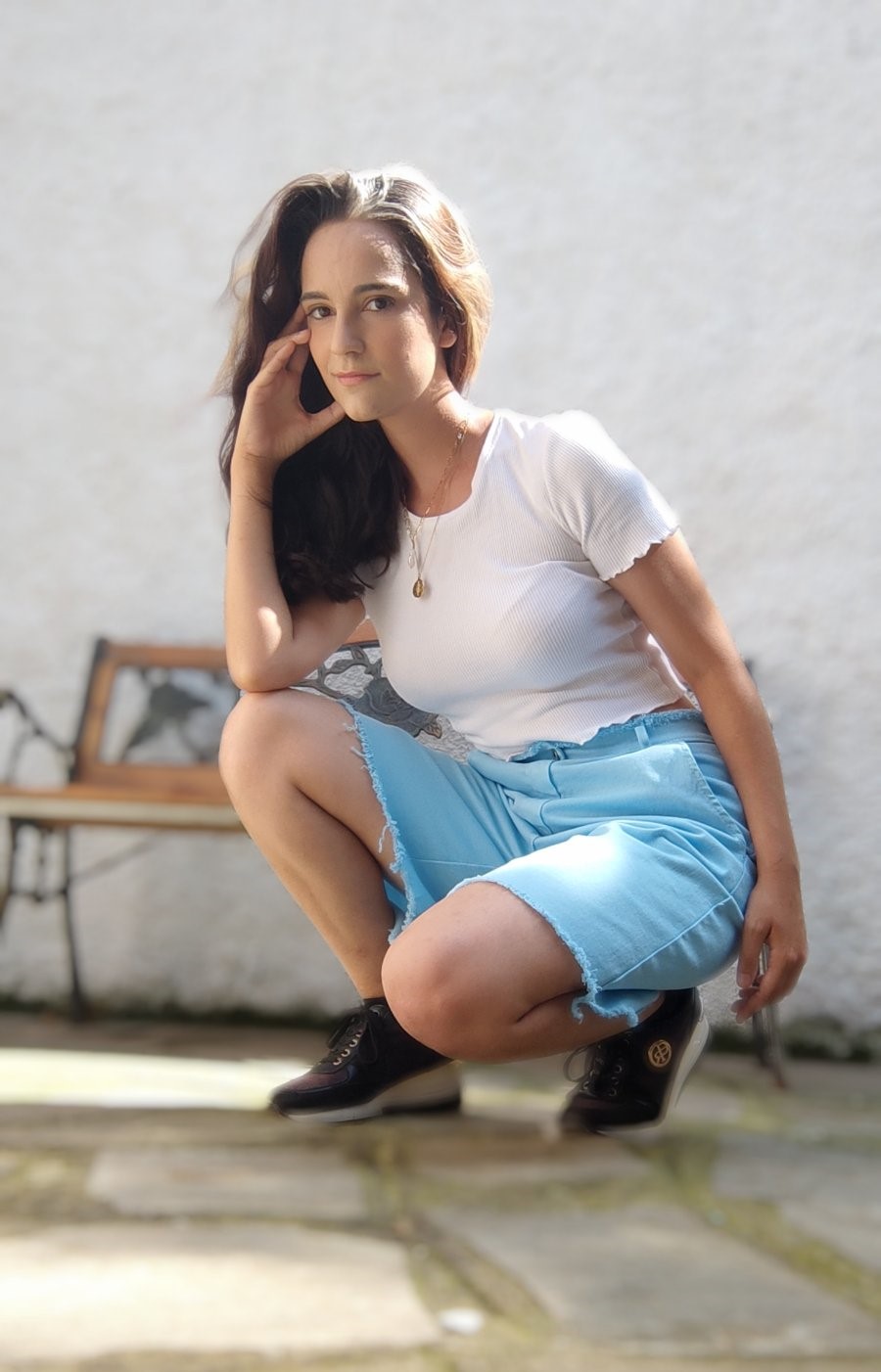 Brunette woman wearing high-waisted jeans shorts with pockets