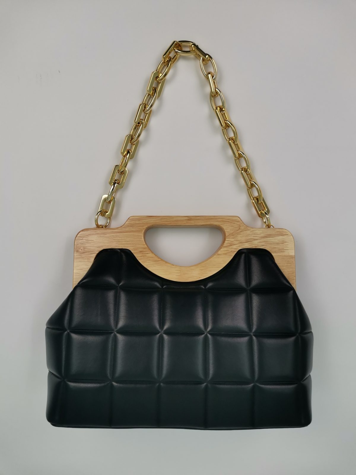 Black bag with wooden handle and gold chain