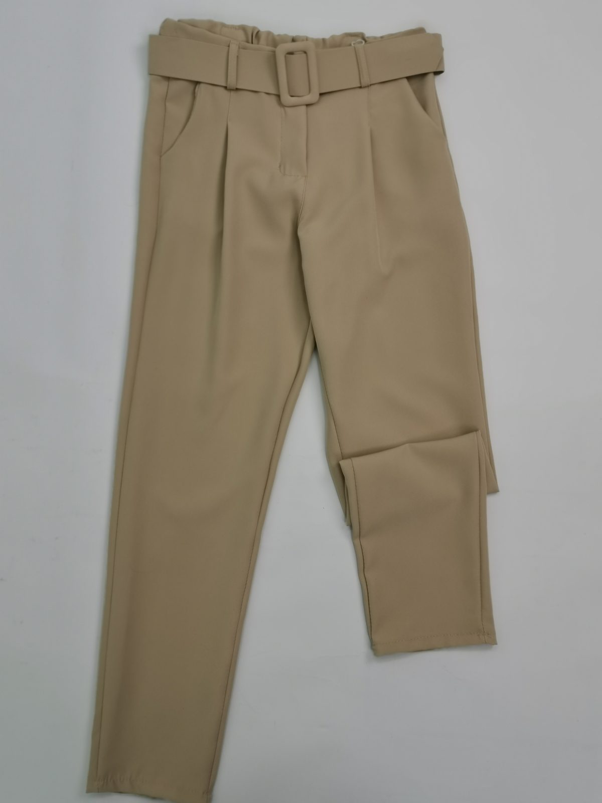 White high-waisted trousers with a beige belt