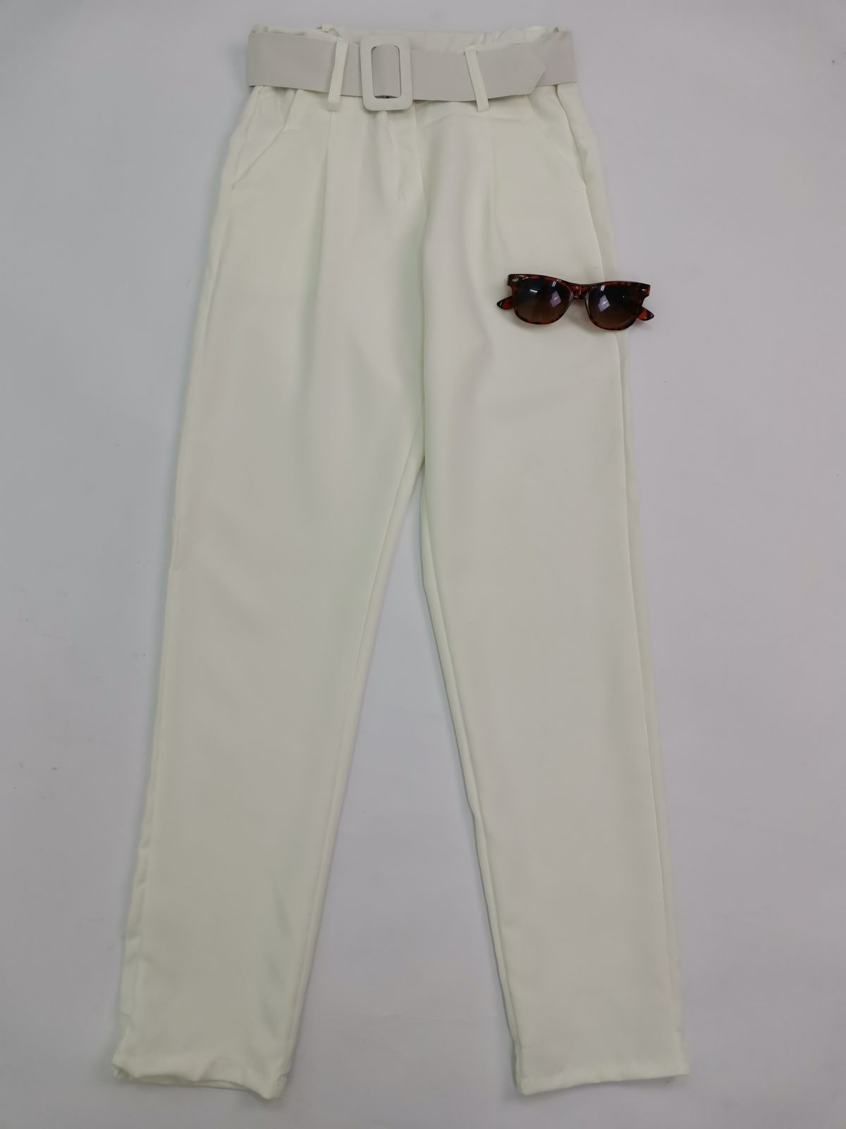 White high-waisted trousers with a white belt