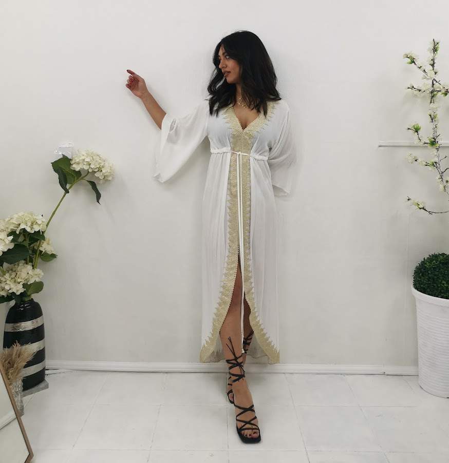 Gauze dress with gold details.